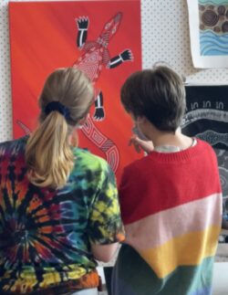 two girls looking at an artwork
