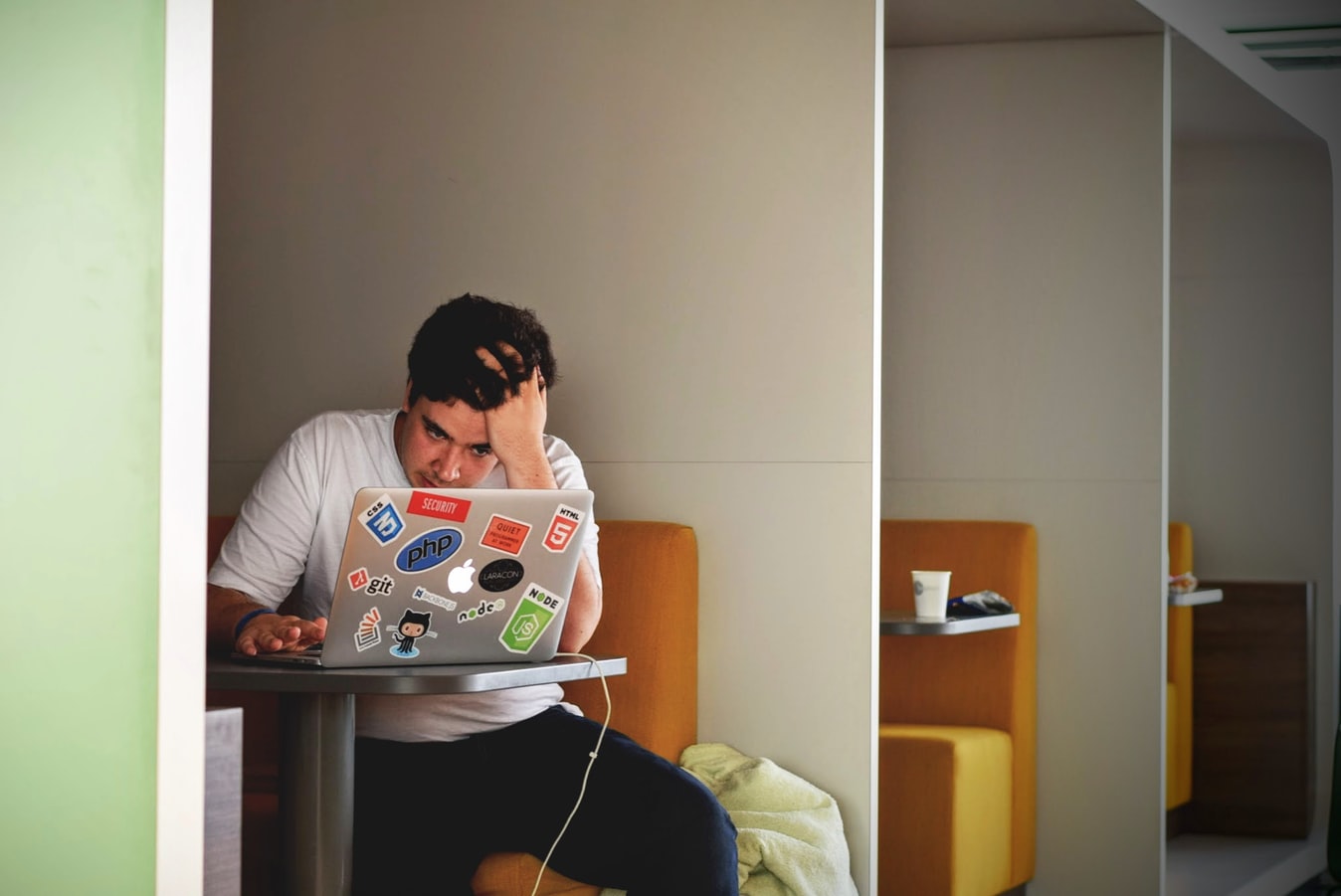stressed man looking at laptop