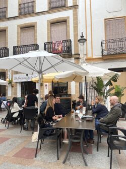 group of people sitting at a cafe during siesta in spain