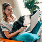 An,Attractive,Young,Woman,In,Glasses,Is,Working,On,A 