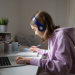 Teen,Girl,School,Pupil,Wearing,Headphones,Studying,Online,From,Home 